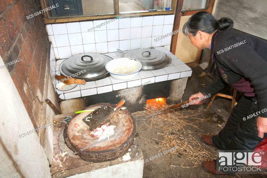 Stock Photo: A traditional kitchen totve in a peasant farmers house in northern China The main fuel for the sotve is dried maize stalks which is renewable and has a zero.