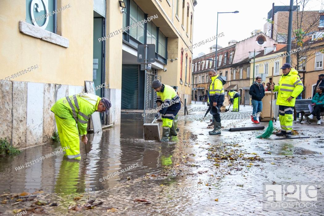 Stock Photo: 13 December 2022, Portugal, Lissabon: Cleanup in front of the Embassy of Angola in Lisbon after a storm. Heavy rains have caused damage to streets.