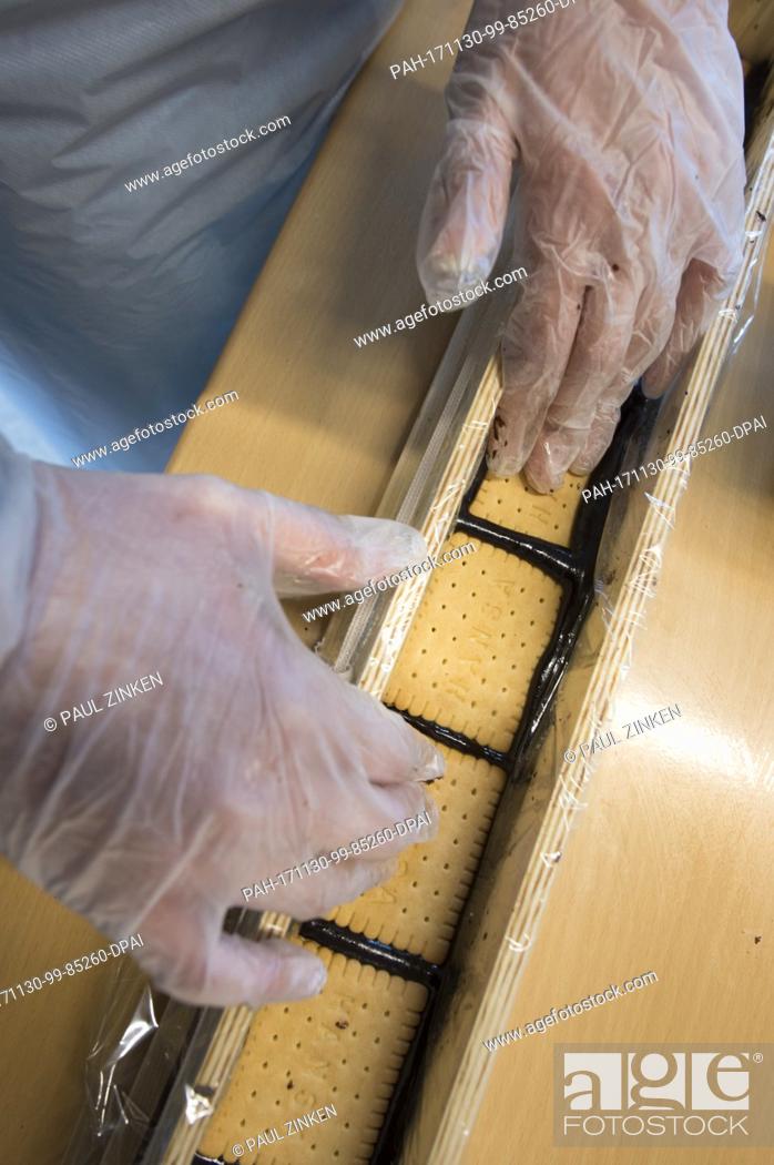 Stock Photo: A student at the Philipp Reis School in Berlin's Lichtenberg helping in the production of a giant hedgehog slice in Berlin, Germany, 30 November 2017.