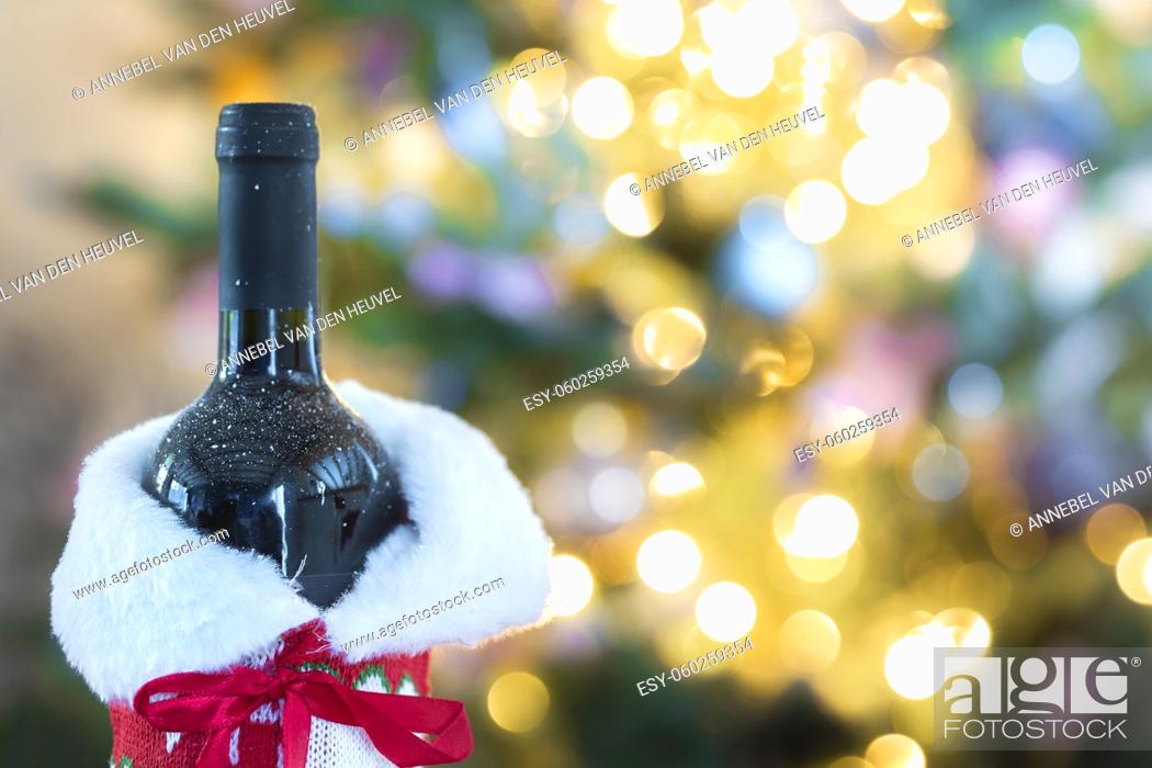 Stock Photo: Luxurious holiday composition, a bottle wine with a Christmas tree and bokeh lights on the background with copy space, Holiday concept space for text.