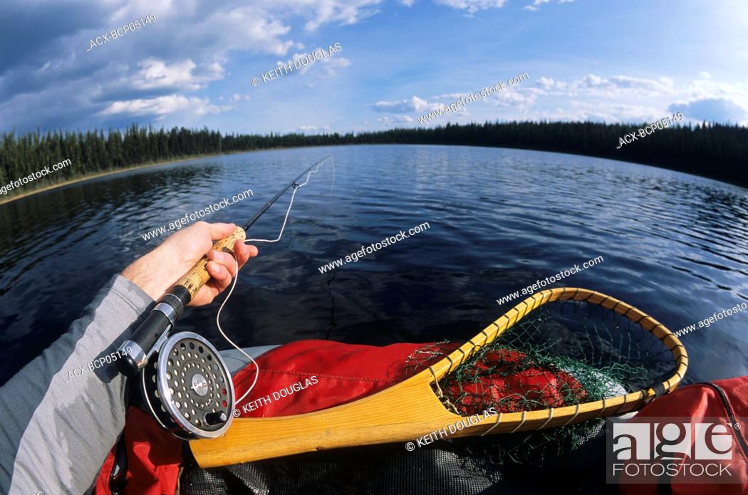 Stock Photo: Flyfishing for trout from float-tube, Llama lake, Smithers, British Columbia, Canada.