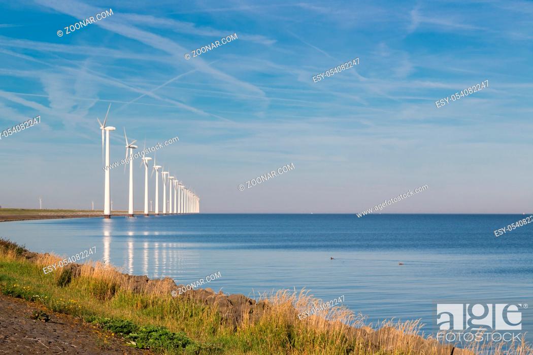 Stock Photo: Long row off shore wind turbines along the Dutch coast.