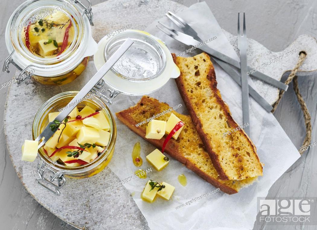 Stock Photo: Pickled cheese served with freshly toasted bread.