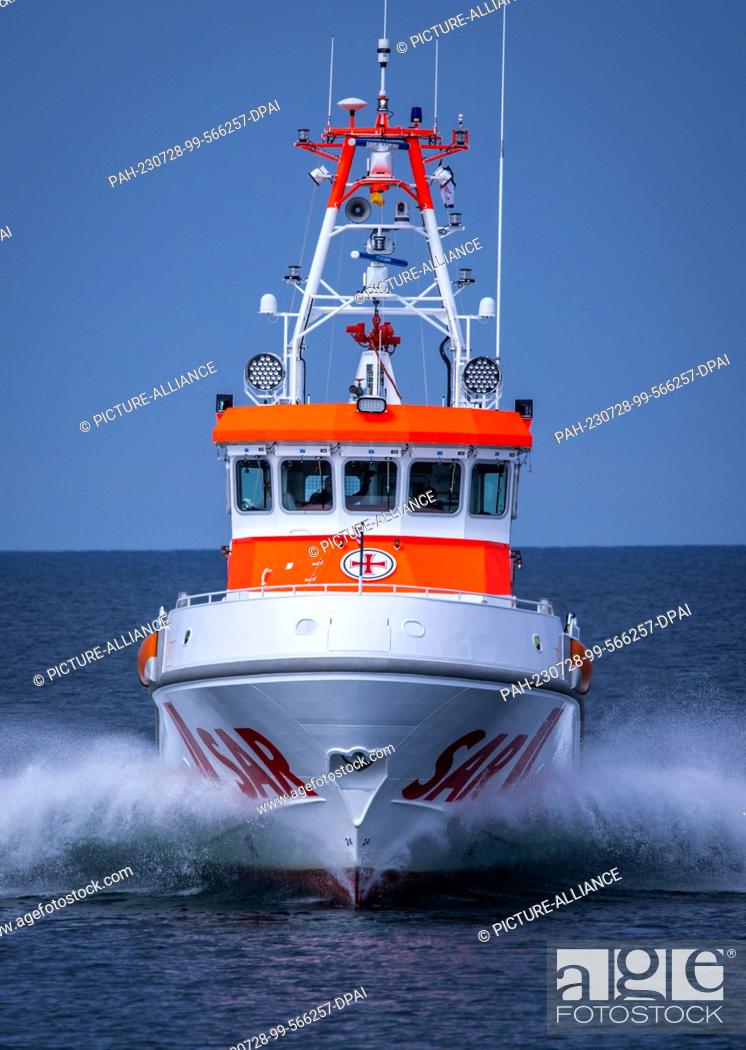 Stock Photo: PRODUCTION - 27 July 2023, Mecklenburg-Western Pomerania, Zingst: The 28-meter-long and nearly 4, 000-horsepower sea rescue cruiser ""Nis Randers"" maneuvers.