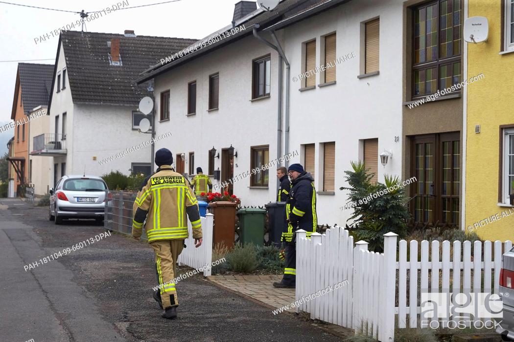 Stock Photo: 04 November 2018, Rhineland-Palatinate, Neuwied: Fire fighters in the streets of the Neuwied district Irlich check whether all residents have left their houses.