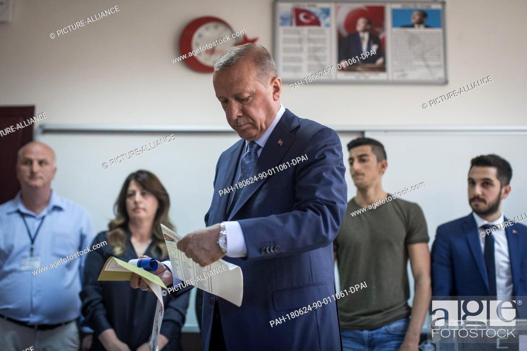 Stock Photo: Turkish President Tayyip Recep Erdogan holds his ballot papers to vote in Turkey's elections at a polling station, in Istanbul, Turkey, 24 June 2018.