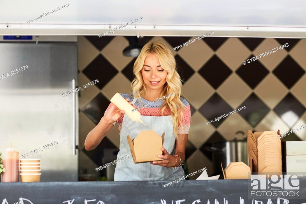 Stock Photo: happy saleswoman making wok at food truck.