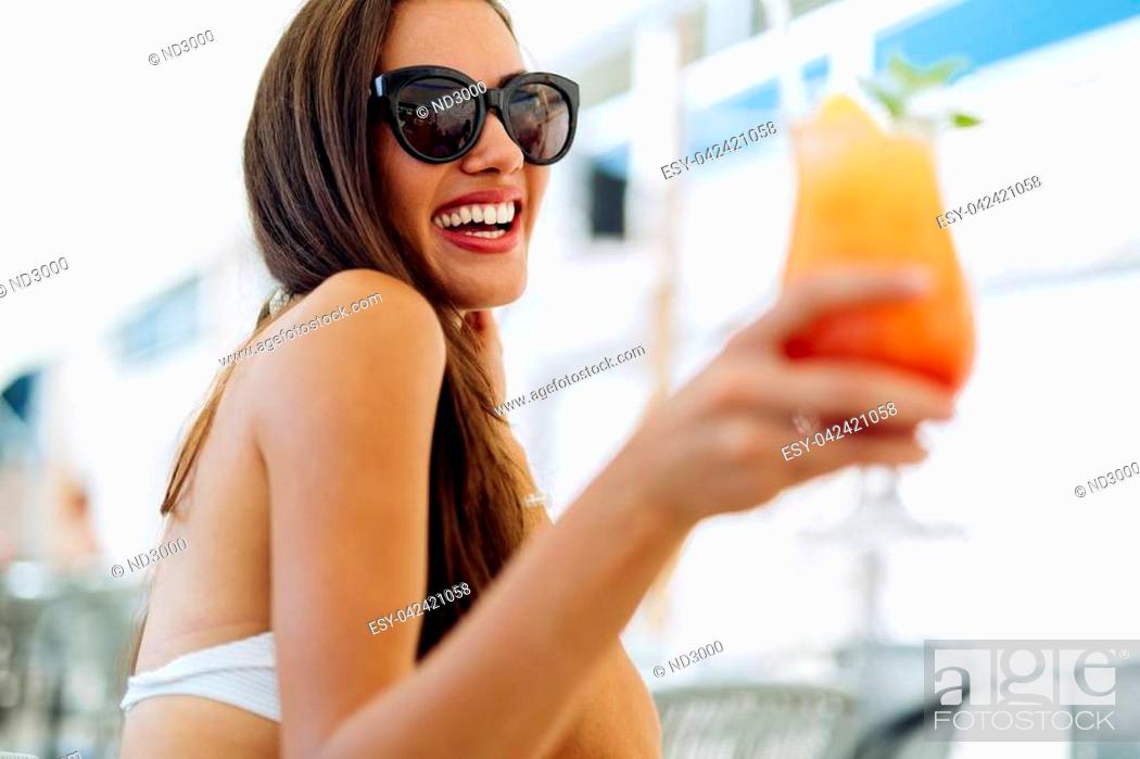Stock Photo: Beautiful woman drinking cocktail in summer.