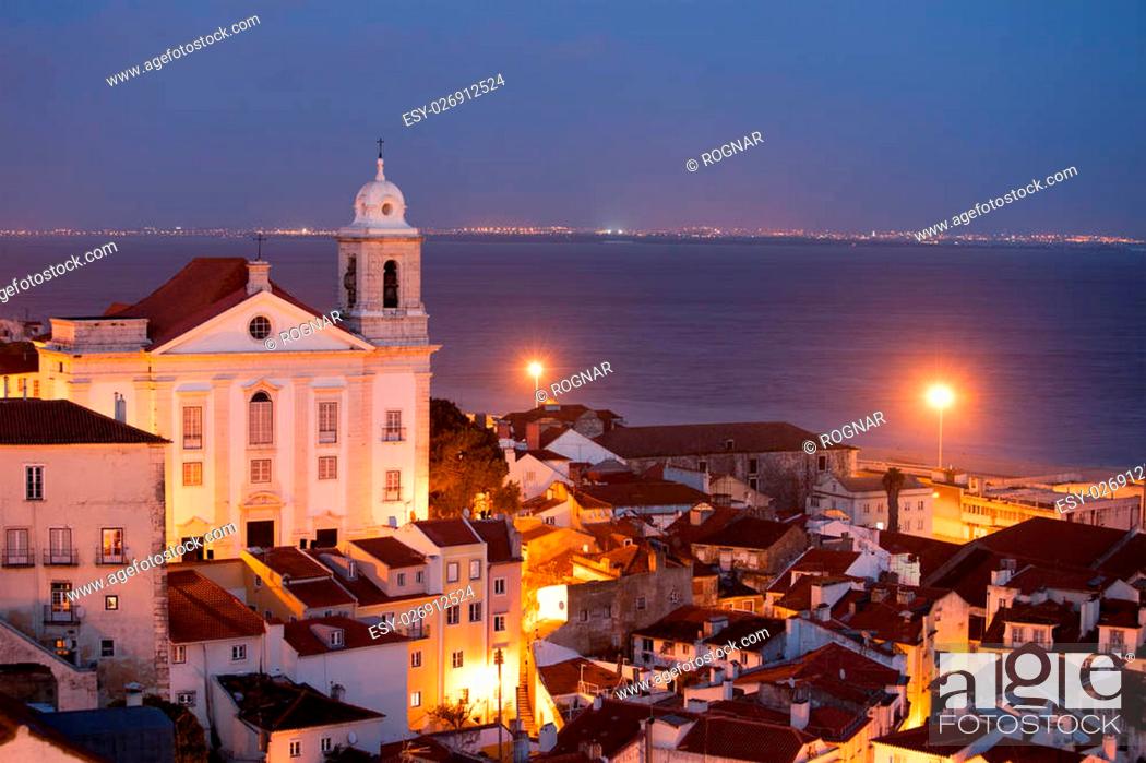 Stock Photo: Santo Estevao church and Lisbon cityscape in Portugal at night.