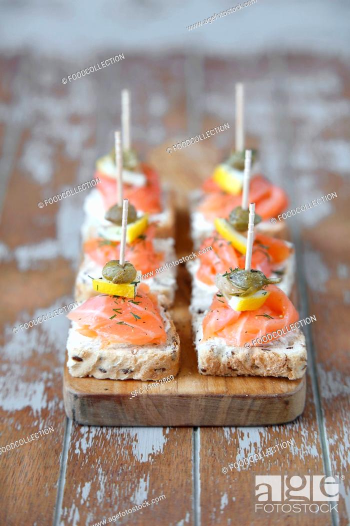 Stock Photo: Mini canapés with smoked salmon and capers.