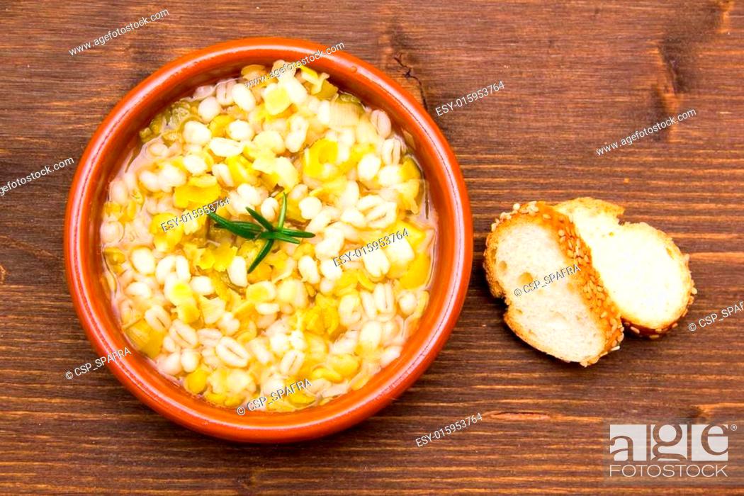 Stock Photo: Spelled soup and vegetables on wooden table top view.