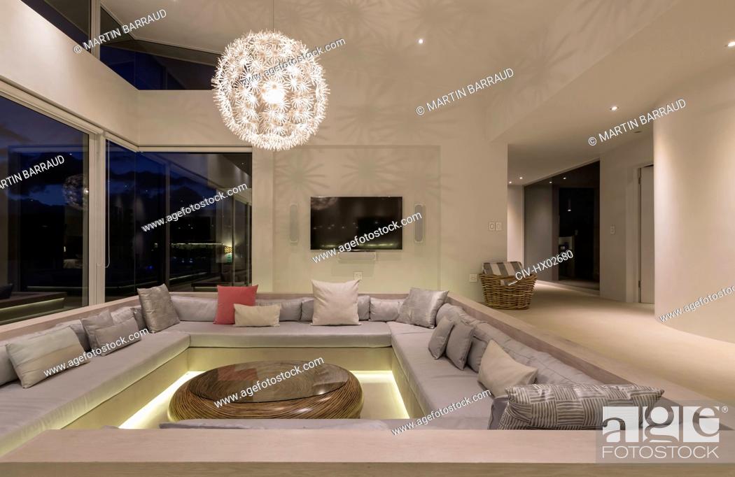 Stock Photo: Illuminated modern luxury home showcase interior living room with chandelier.