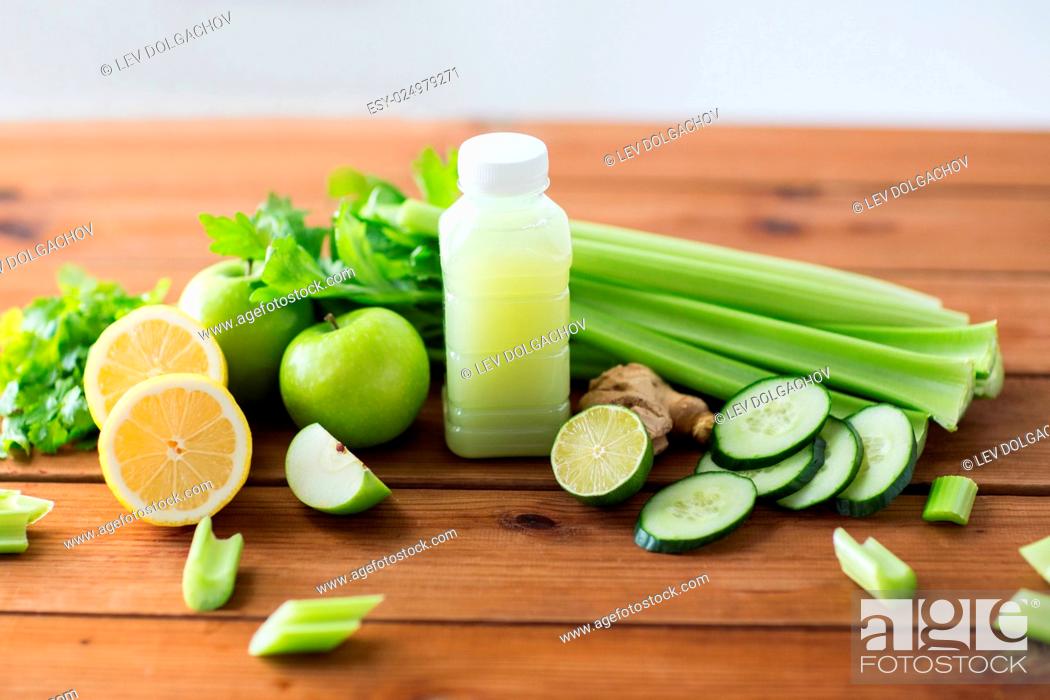 Stock Photo: healthy eating, food, dieting and vegetarian concept - bottle with green juice, fruits and vegetables on wooden table.