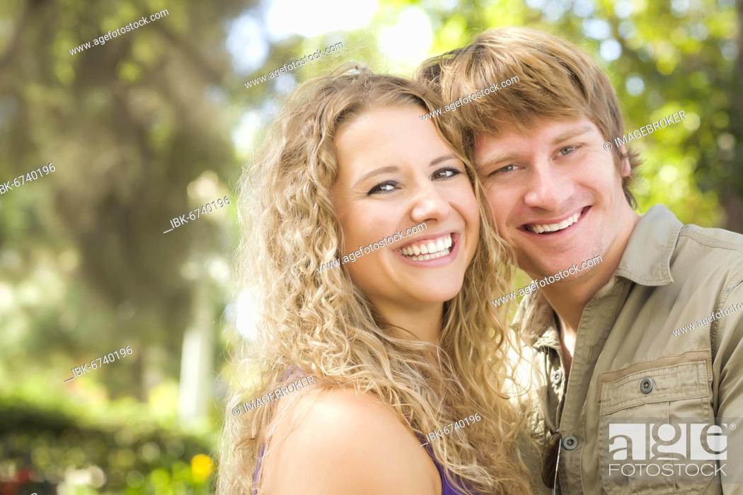 Stock Photo: Happy attractive loving couple portrait in the park.