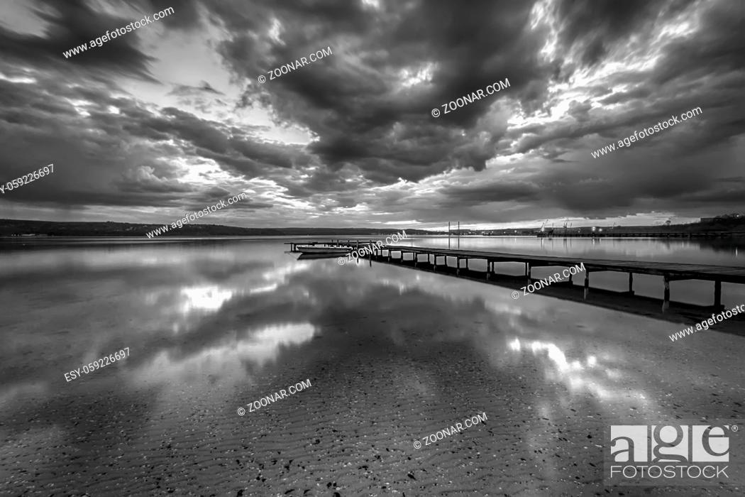 Stock Photo: Stunning black and white long exposure seascape with clouds reflection.