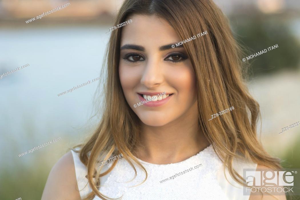 Stock Photo: Beautiful woman smiling outdoors.