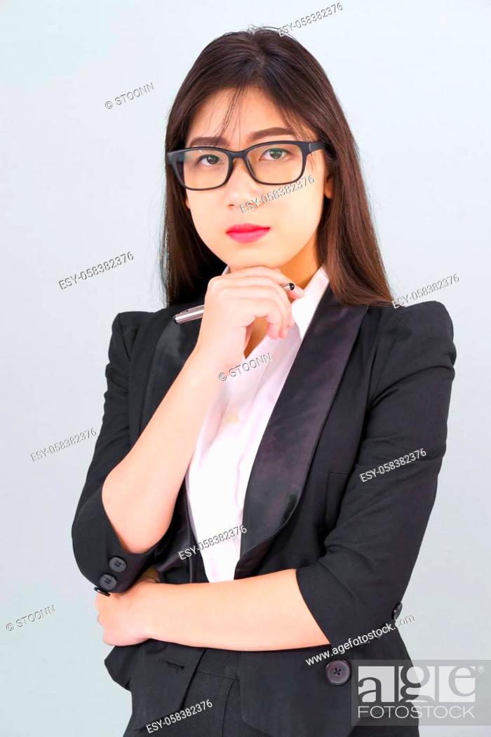 Stock Photo: Teenage young asian wearing suit with support hand on chin isolated.