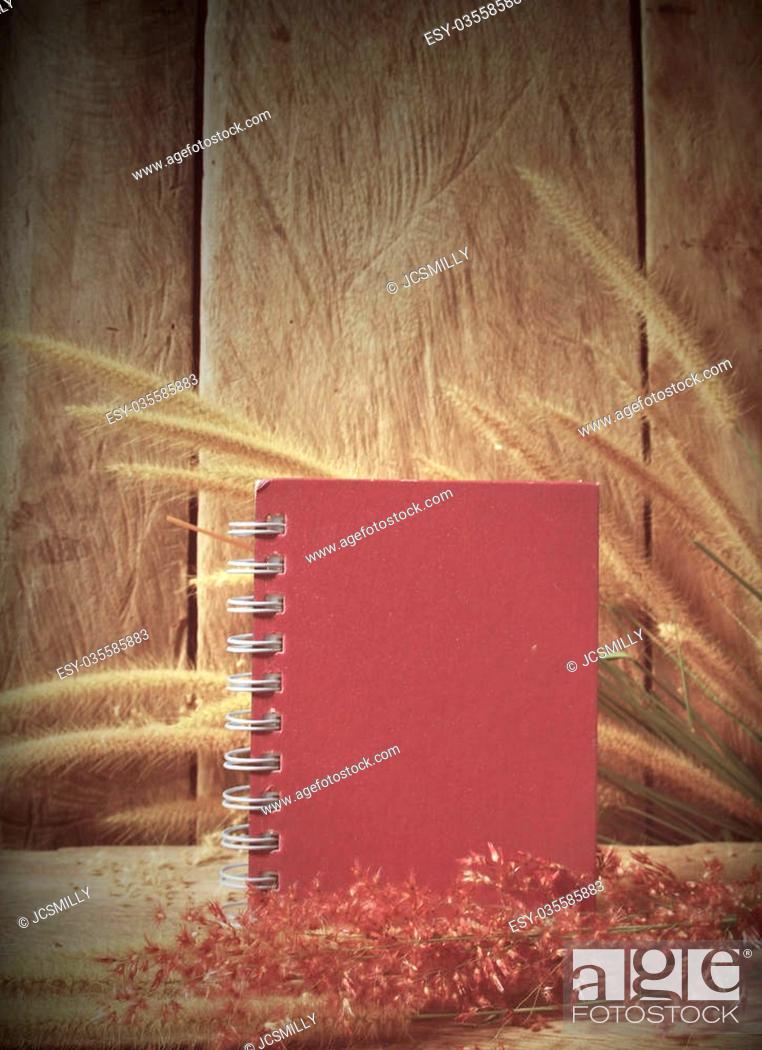 Stock Photo: Still life notebook with foxtail grass on grunge wooden background, vintage style.