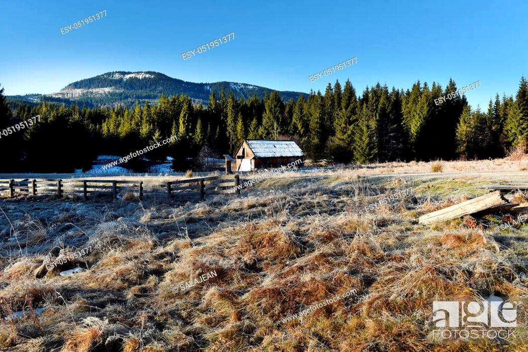 Stock Photo: Wooden cottage in the mountains in a cold winter morning.