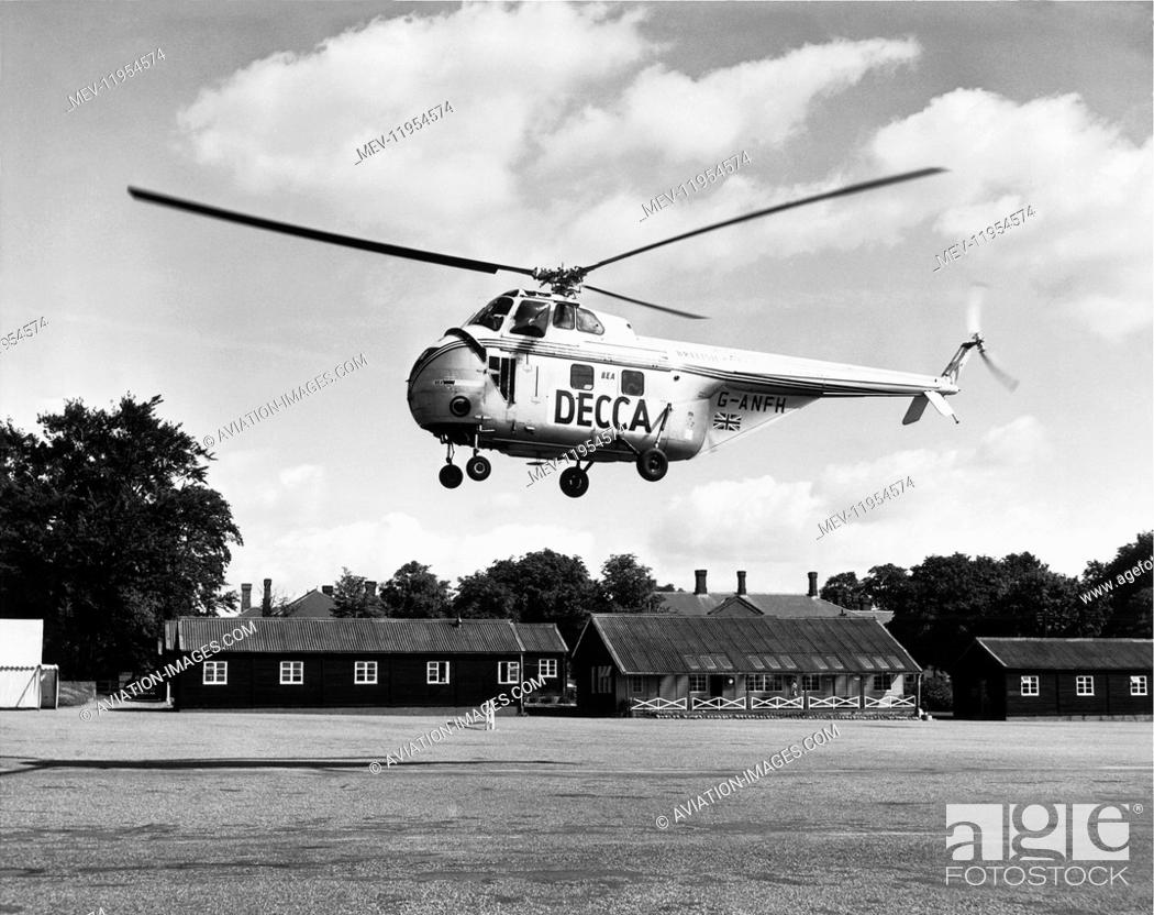 Stock Photo: Bea Helicopters British European Airways Sikorsky Westland Ws-55 Whirlwind Series 1 Flying with Special-Livery Titles of Decca with Airport Buildings Behind.