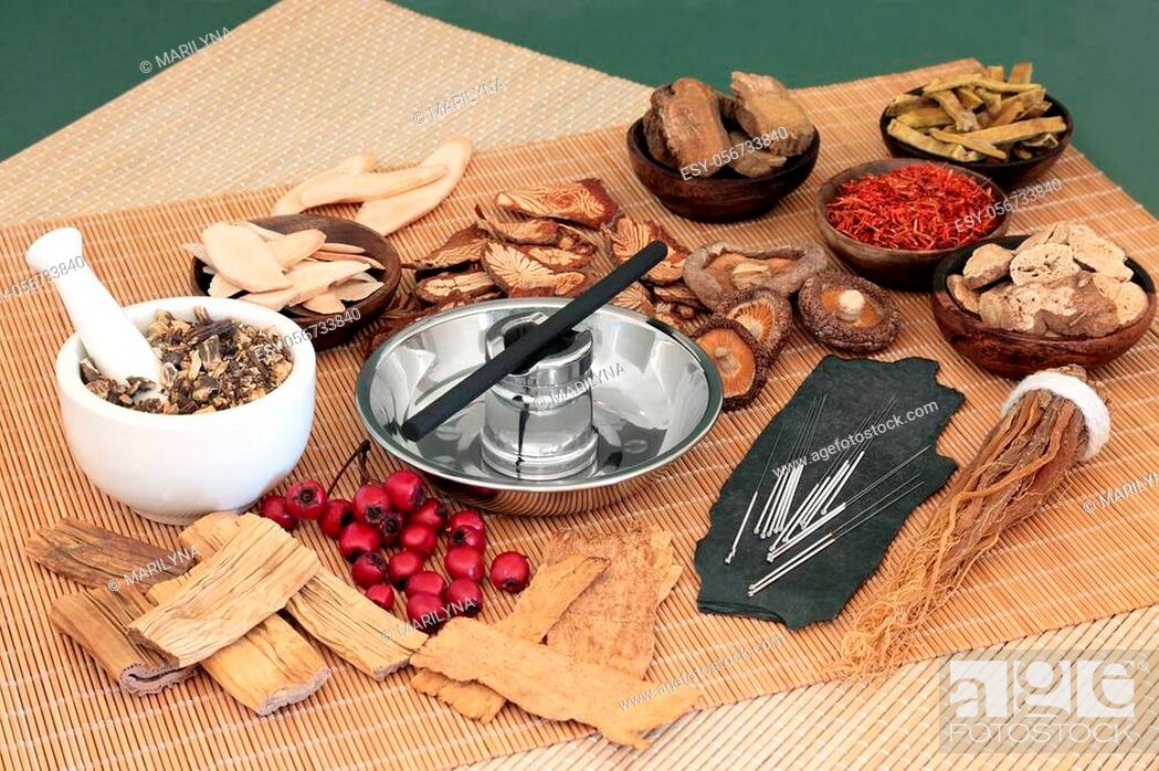 Stock Photo: Traditional Chinese herbs used in herbal medicine with acupuncture needles and moxa stick used in moxibustion therapy on bamboo mats and green background.