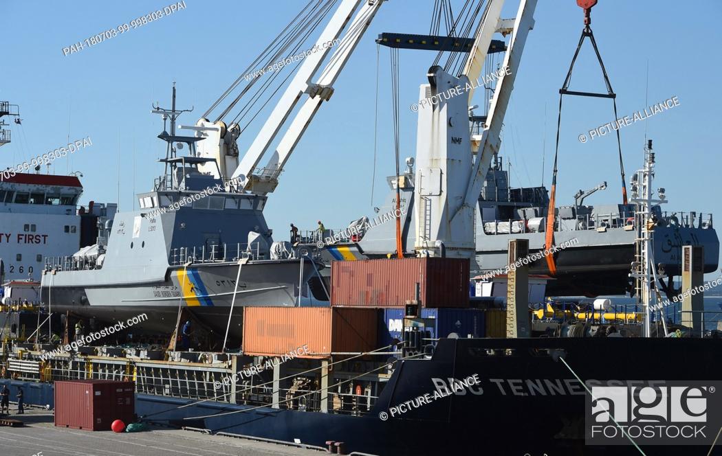 Stock Photo: 03 July 2018, Germany, Sassnitz: A coast guard boat for Saudi Arabia being loaded on a transport ship in the port of Mukran.