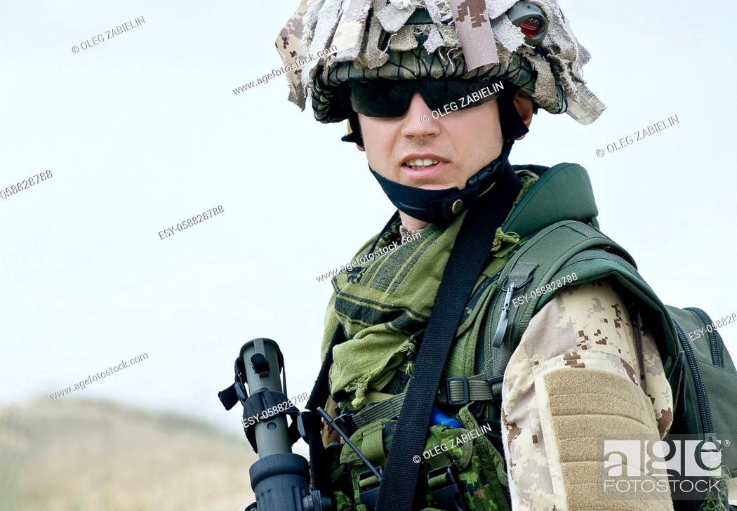 Stock Photo: soldier in desert uniform holding his rifle.