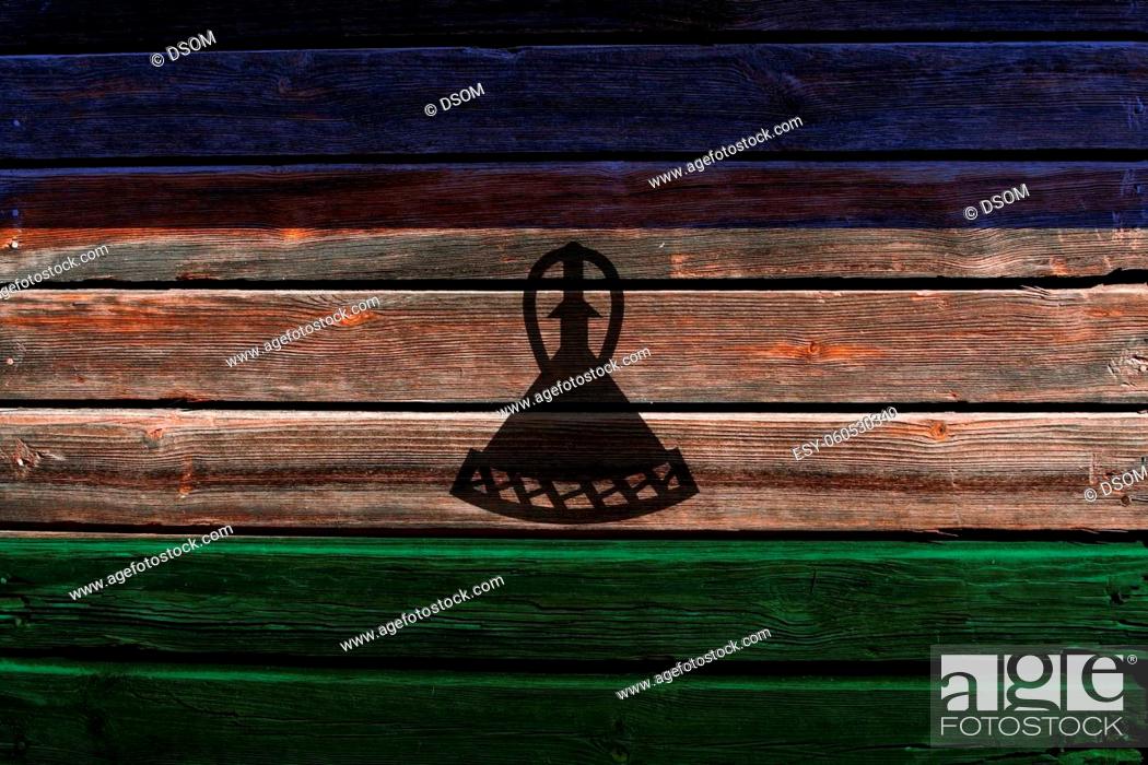 Stock Photo: 3D Flag of Lesotho on a old wood wall background.