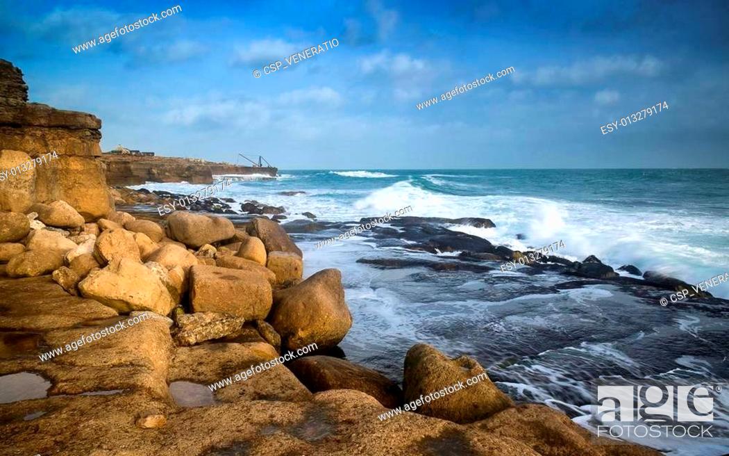 Stock Photo: Seascape landscape of waves crashing onto rocks during beautiful Winter's day.