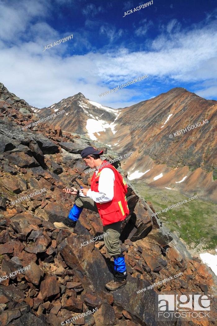 Stock Photo: Geologist doing fieldwork, Hudson Bay Mountain, Smithers, British Columbia.
