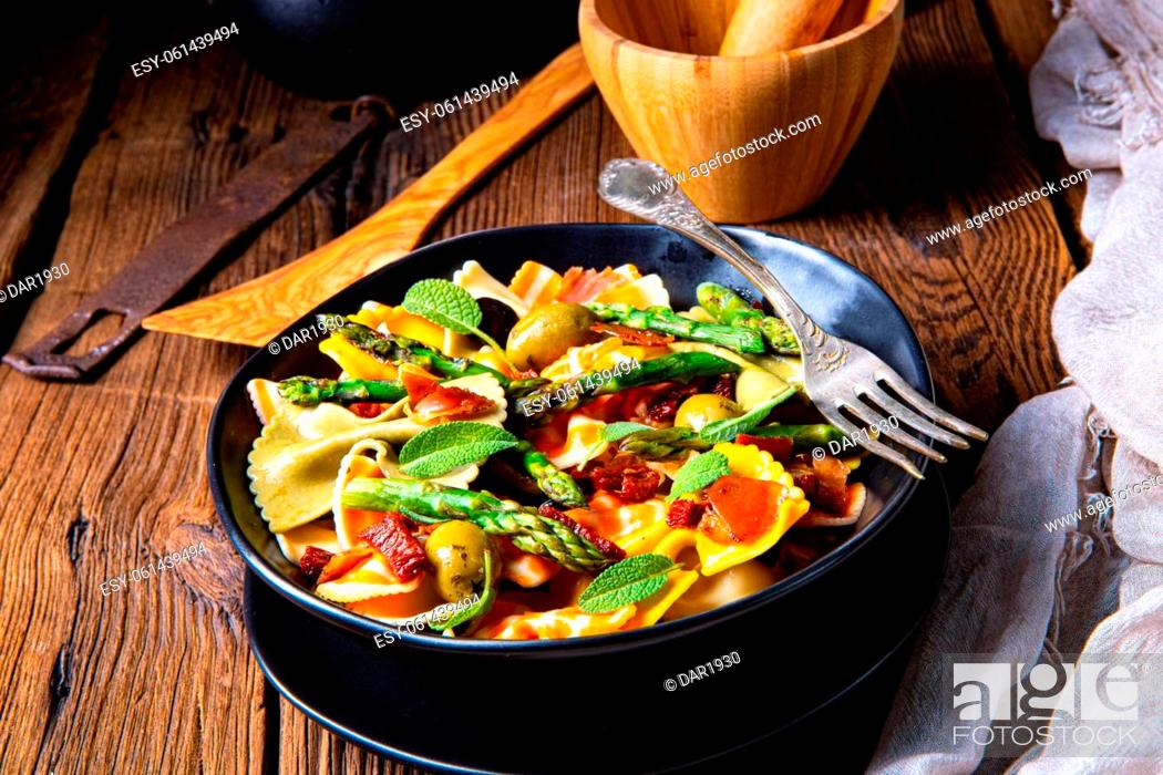 Stock Photo: Pasta salad with green asparagus, olives and parma ham.