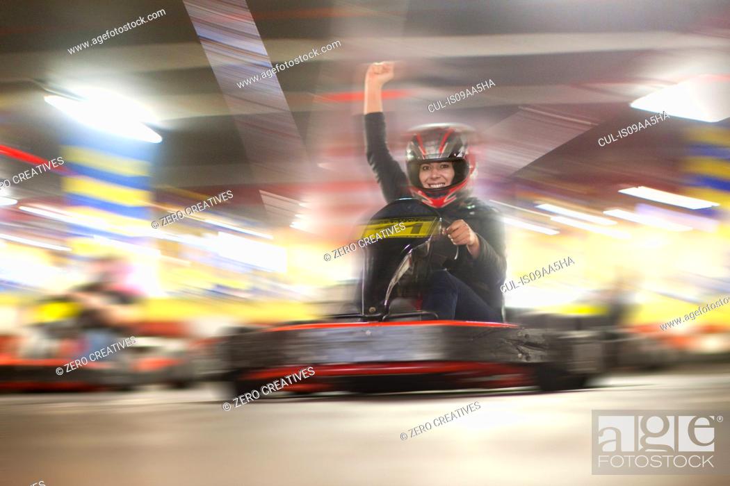 Stock Photo: Mid adult woman driving go cart.