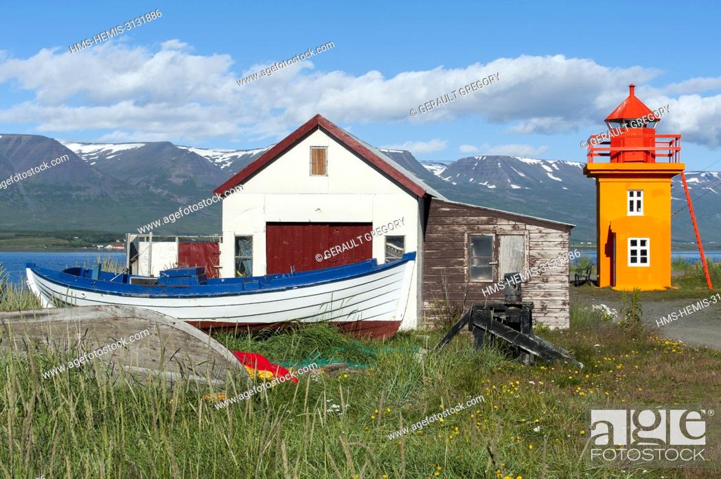 Stock Photo: Iceland, North East Iceland, Akureyri, Svalbardseyri, orange lighthouse, building, boat.