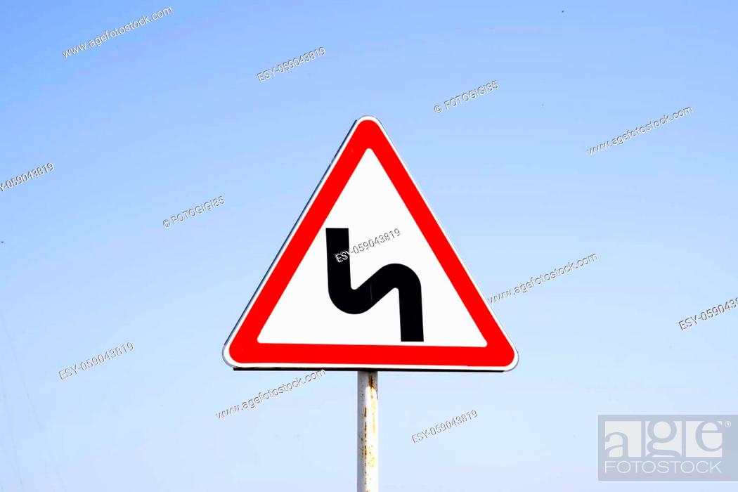 Stock Photo: Road sign dangerous turn. Warning a sign.