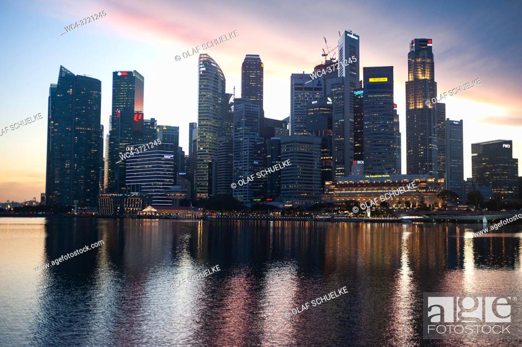 Stock Photo: Singapore, Republic of Singapore, Asia - General view across Marina Bay of the illuminated central business district with its modern skyscrapers at dusk amid.