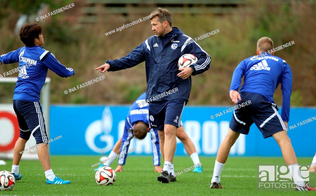 Stock Photo: FC Schalke 04's assistant coach Sven Huebscher (C) in action during the training session in Gelsenkirchen,  Germany, 07 October 2014.