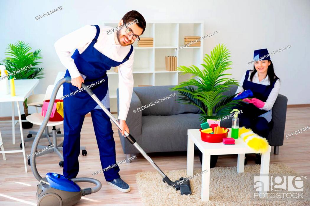 Stock Photo: Cleaning service team vaccuuming, dusting and watering plants.