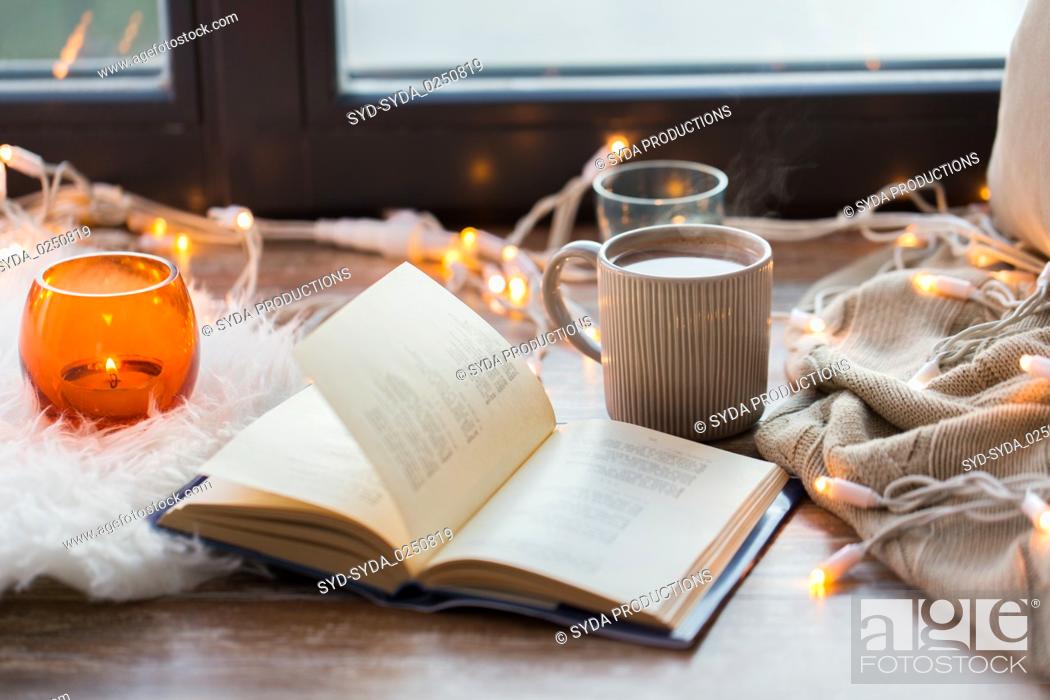 Stock Photo: book and coffee or hot chocolate on window sill.