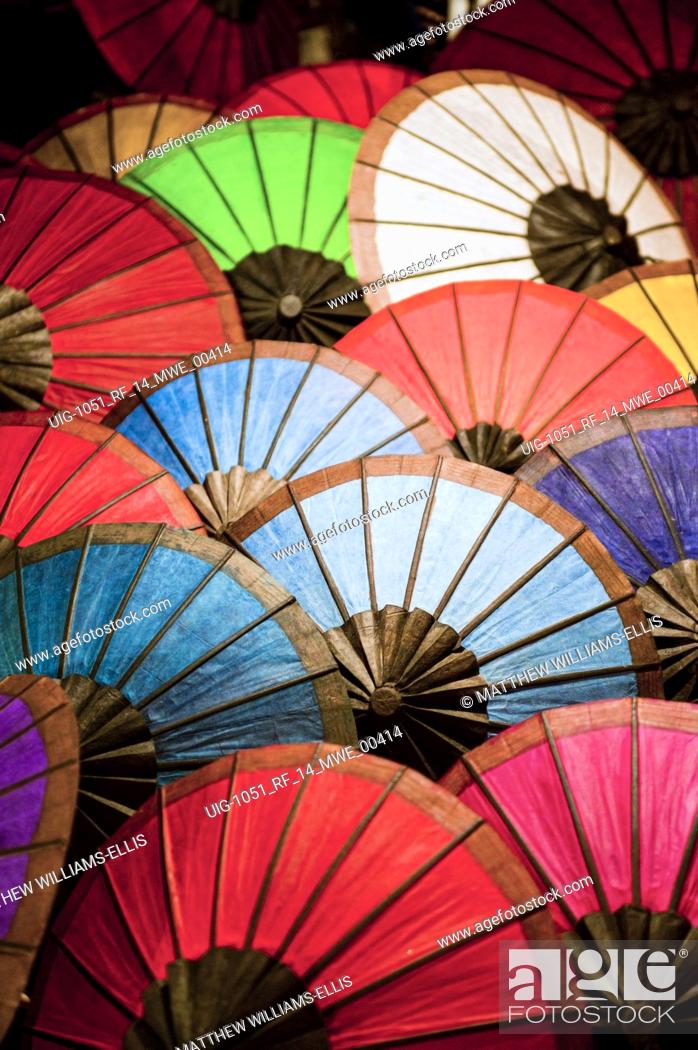Stock Photo: Colourful umbrellas for sale at market stalls at the night market in Luang Prabang, Laos NB: This photo contains some levels of noise.