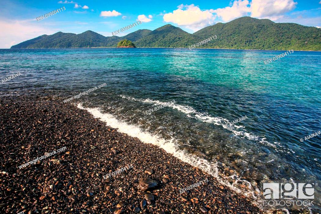 Stock Photo: Beautiful crystal clear sea with black pebble beach at tropical island, Koh Lipe, Andaman sea, Thailand.