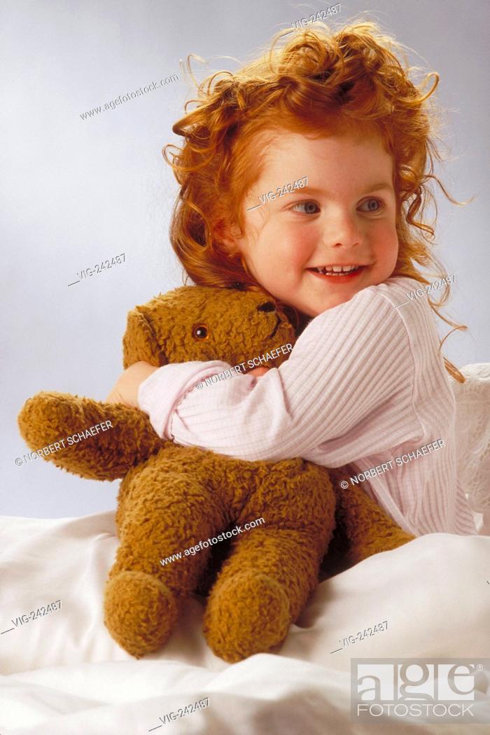 portrait, indoor, smiling 7-year-old girl with red curly hair wearing a  white shirt holds her teddy..., Stock Photo, Picture And Rights Managed  Image. Pic. VIG-242487 | agefotostock