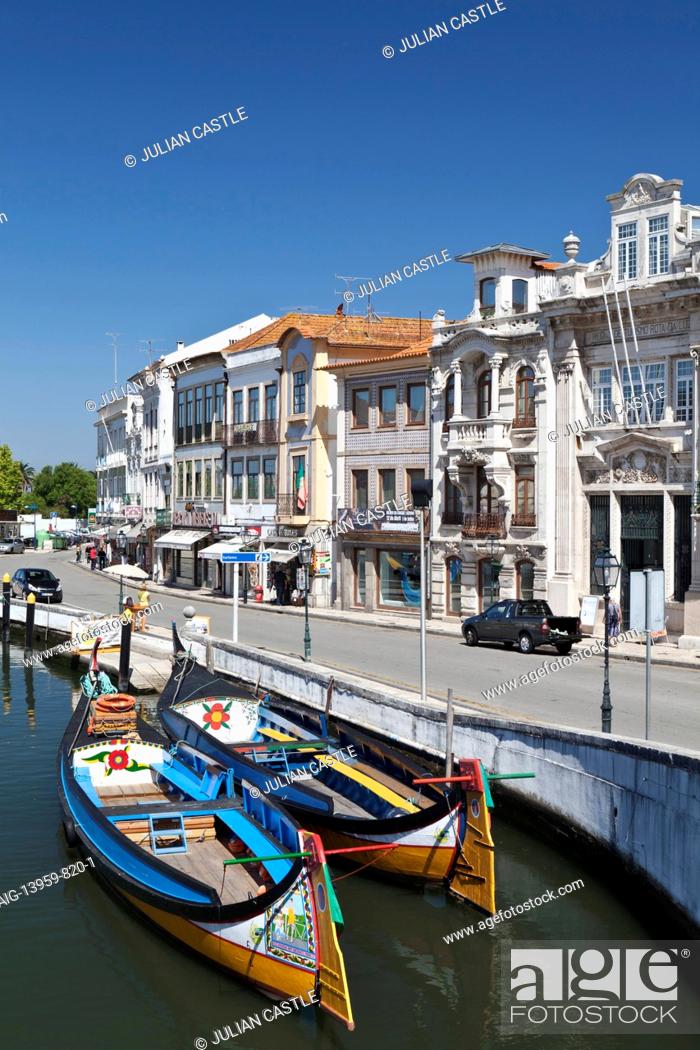 Stock Photo: Art Nouveau buildings and traditional moliceiros boats moored on the canal at Aveiro, Portugal.