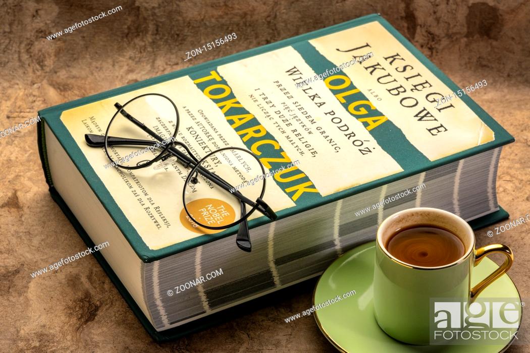 Stock Photo: Fort Collins, CO, USA - March 8, 2020: The Books of Jacob (Polish edition), historical novel by Olga Tokarczuk with coffee and reading glasses - 2018 Nobel.