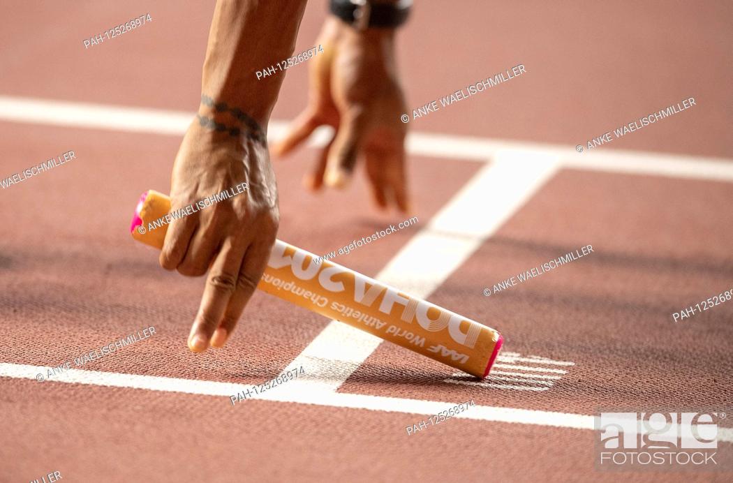 Stock Photo: Feature, baton with hands on the start, staff, final 4x100m Men's relay, on 05.10.2019 World Athletics Championships 2019 in Doha / Qatar, from 27.09.
