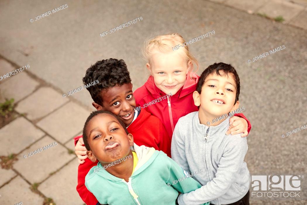 Stock Photo: Smiling children standing together and looking at camera.