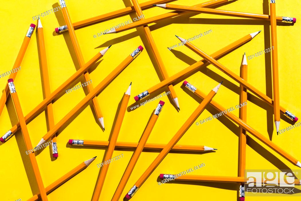 Stock Photo: Pencils: pattern of orange pencils from above on yellow background. Office and school concept.