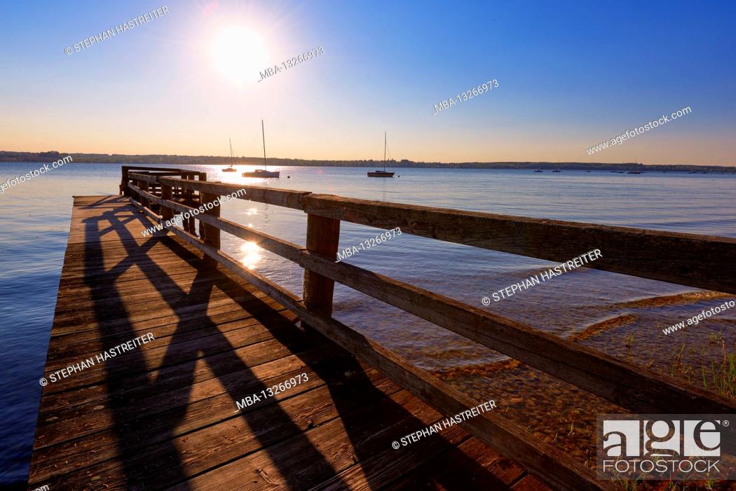 Stock Photo: Evening mood on the Ammersee with a jetty.