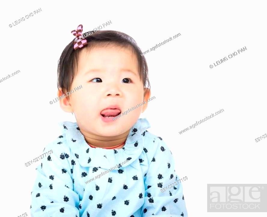 Stock Photo: Asian baby girl lick sticking out.
