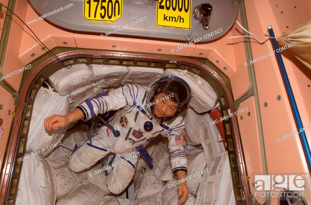 Stock Photo: Wearing a Russian Sokol suit, astronaut Leroy Chiao, Expedition 10 commander and NASA ISS science officer, floats in a hatch in the Unity node of the.