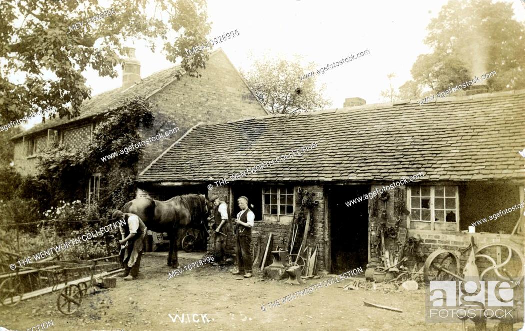 Stock Photo: Blacksmith, Wick, Pershore, near Evesham, Worcestershire, England. Showing Mr Sherwood Shoeing a Horse - May 1909.